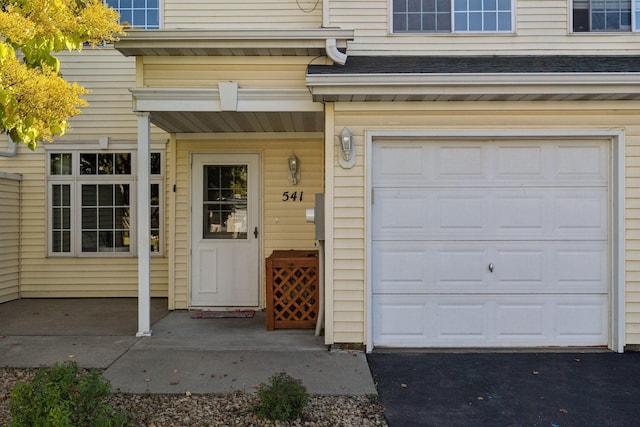 doorway to property with a garage