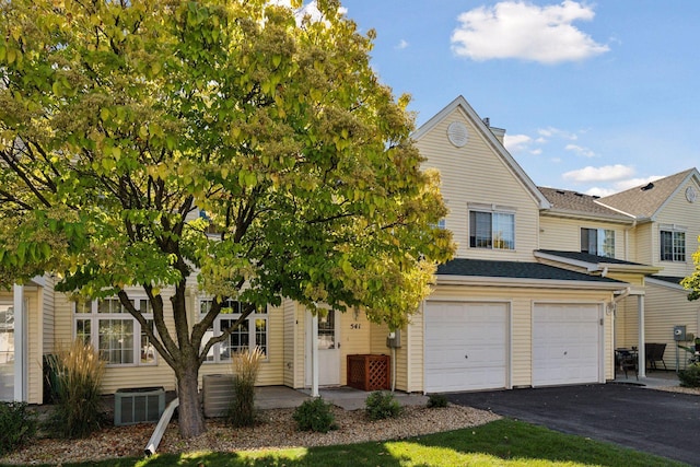 view of front of property with cooling unit and a garage