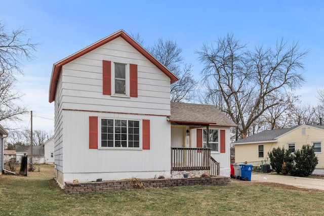 view of front of property featuring central AC, a porch, and a front yard