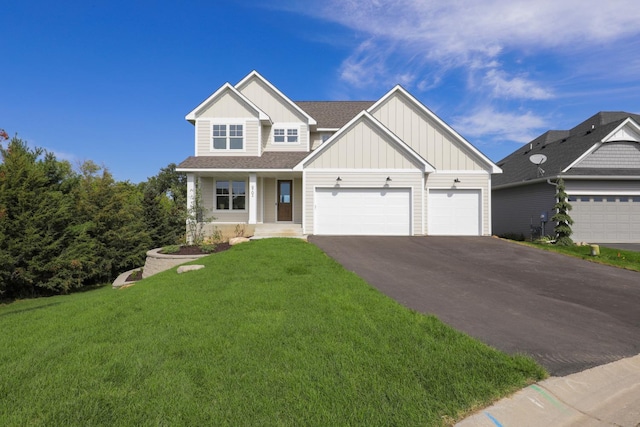 craftsman-style house featuring a front yard and a garage