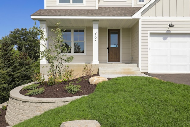 doorway to property with a lawn and a porch