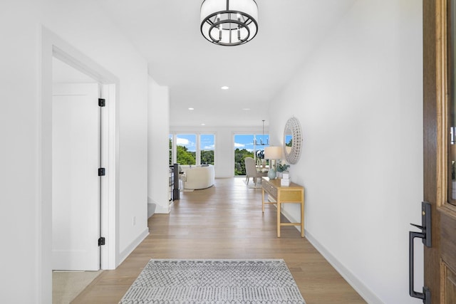 hallway with light hardwood / wood-style floors