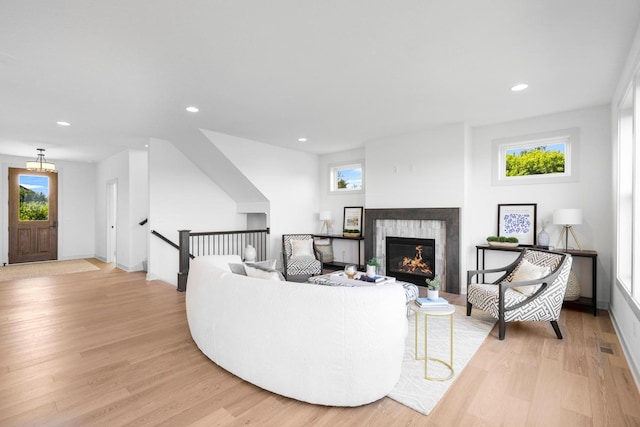 living room featuring light hardwood / wood-style floors and a tile fireplace