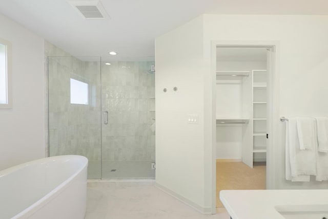 bathroom with shower with separate bathtub