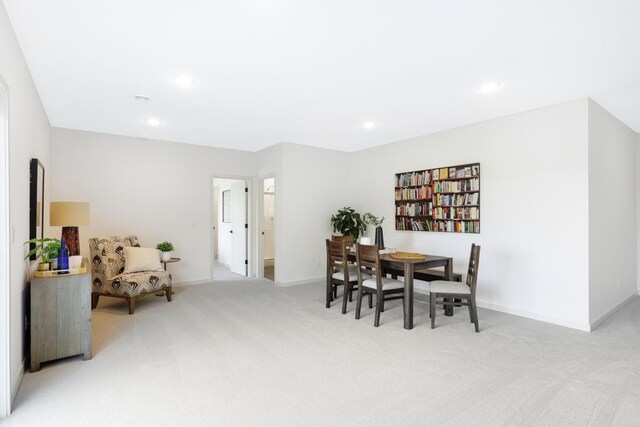 dining area featuring light carpet