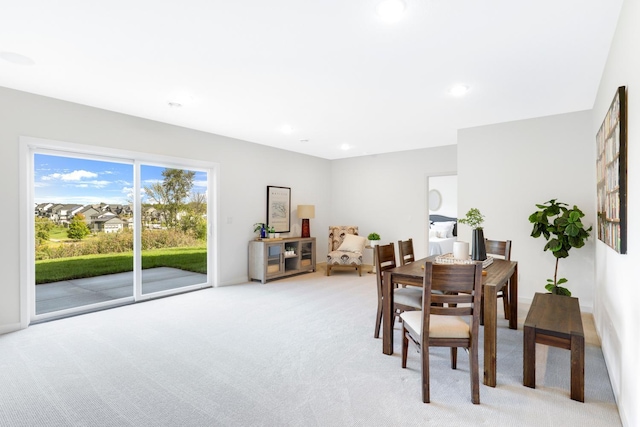 dining space featuring light colored carpet