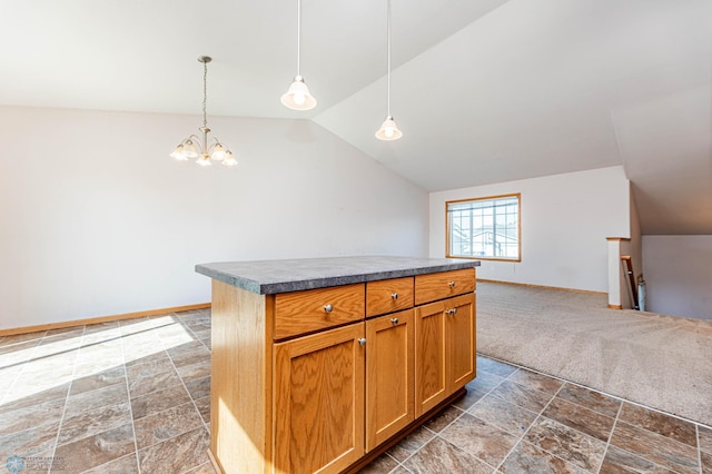 kitchen with hanging light fixtures, vaulted ceiling, a kitchen island, an inviting chandelier, and dark colored carpet