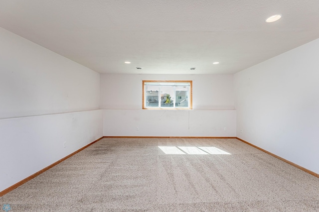 empty room with a textured ceiling and carpet