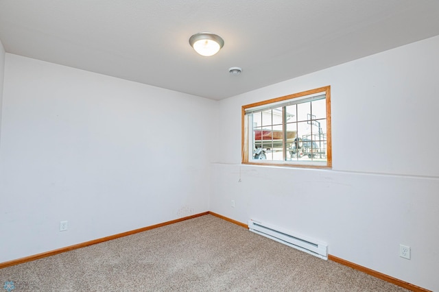 empty room featuring carpet and baseboard heating