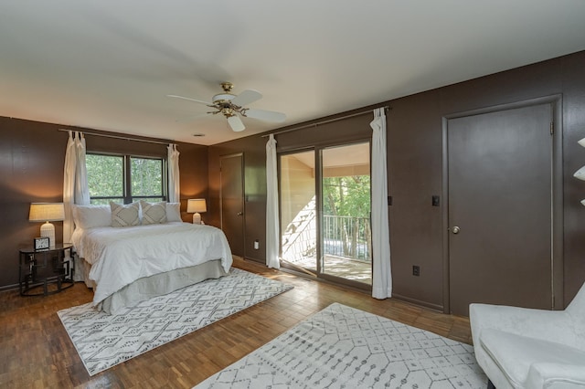 bedroom with ceiling fan, hardwood / wood-style flooring, and multiple windows