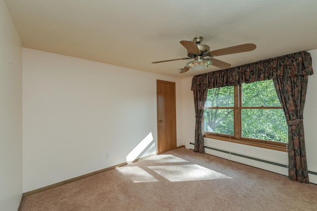 carpeted empty room featuring a baseboard radiator and ceiling fan