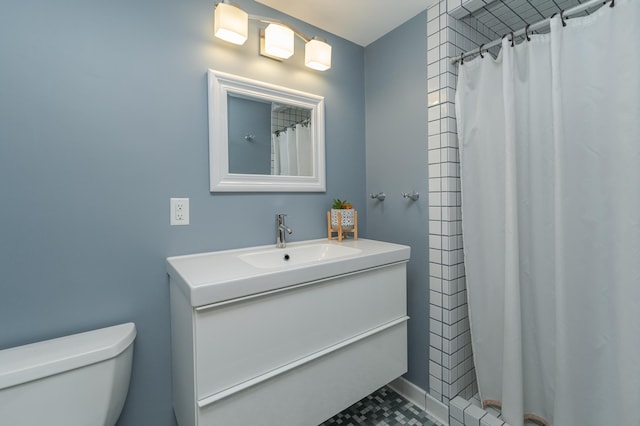 bathroom featuring a shower with shower curtain, tile patterned floors, vanity, and toilet