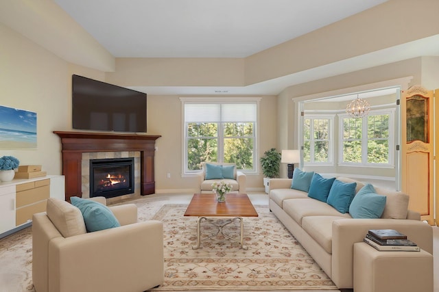 living room featuring a chandelier and a fireplace