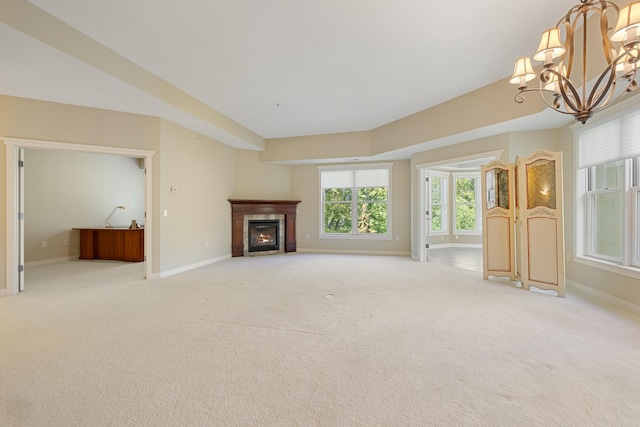 unfurnished living room with light colored carpet and a notable chandelier