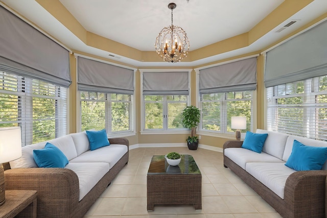 interior space with an inviting chandelier and a raised ceiling