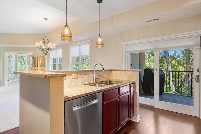 kitchen featuring dishwasher, dark wood-type flooring, sink, and a wealth of natural light