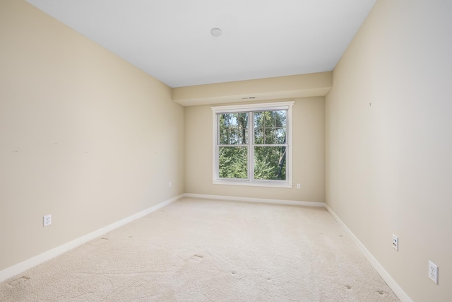 unfurnished room with light carpet