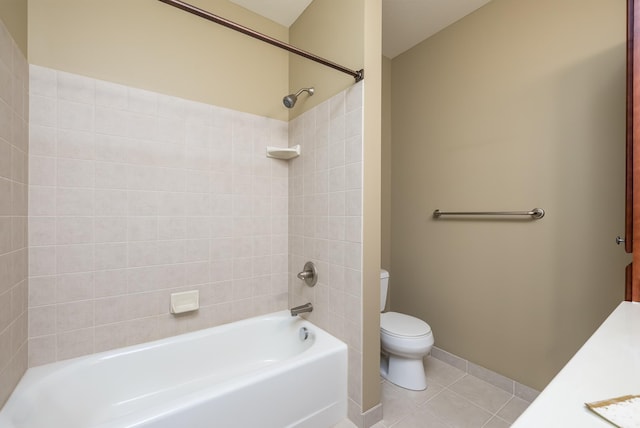 bathroom featuring tiled shower / bath combo, toilet, and tile patterned floors