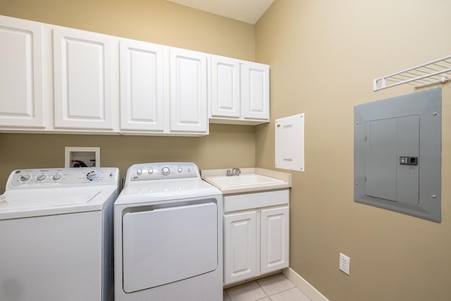 clothes washing area with electric panel, sink, light tile patterned floors, washer and clothes dryer, and cabinets