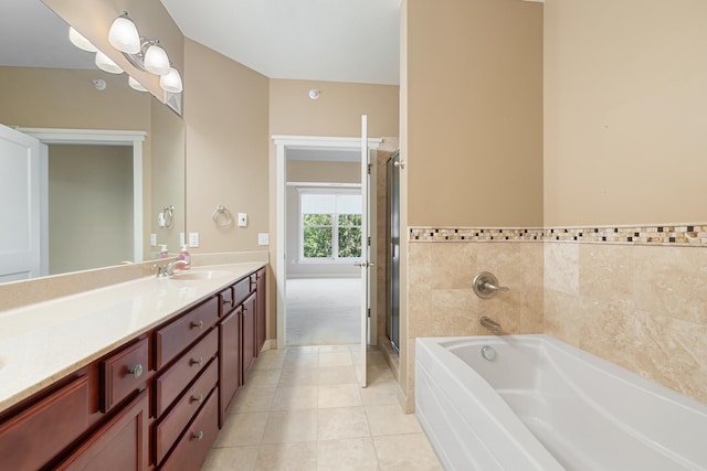 bathroom with tile patterned floors, independent shower and bath, and vanity