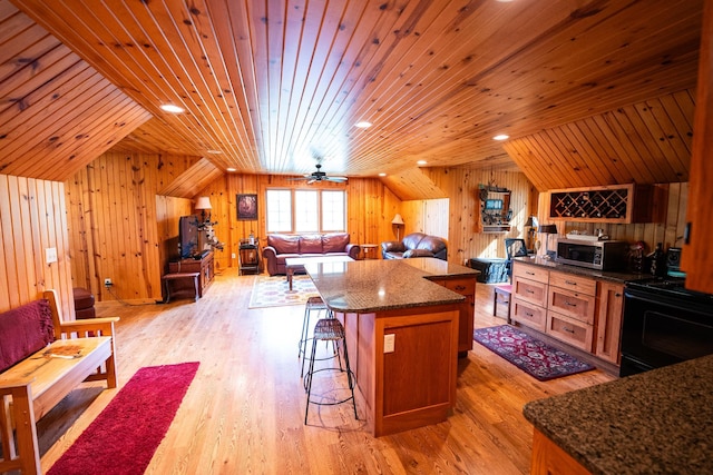 kitchen with light wood-type flooring, wood ceiling, wooden walls, and ceiling fan