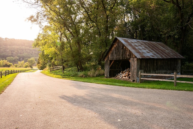 surrounding community featuring a rural view and an outbuilding