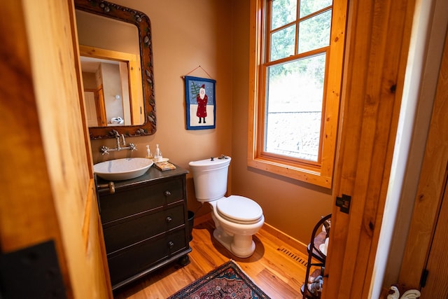 bathroom featuring hardwood / wood-style floors, vanity, and toilet