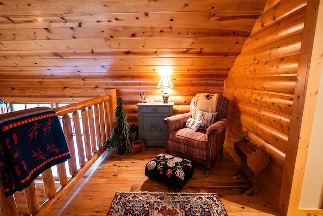 living area with light hardwood / wood-style flooring and wooden ceiling