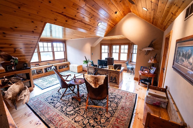 dining area with light wood-type flooring, wooden ceiling, and a healthy amount of sunlight