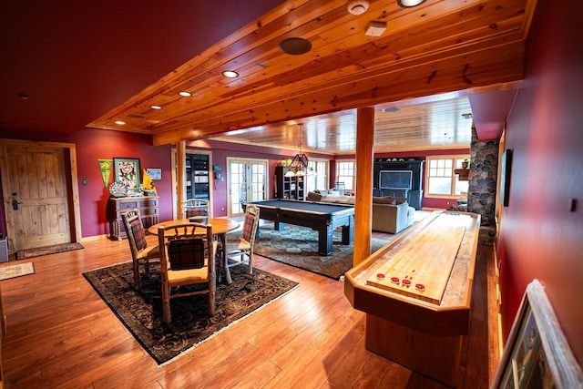 dining area with billiards, light hardwood / wood-style floors, wood ceiling, and a healthy amount of sunlight