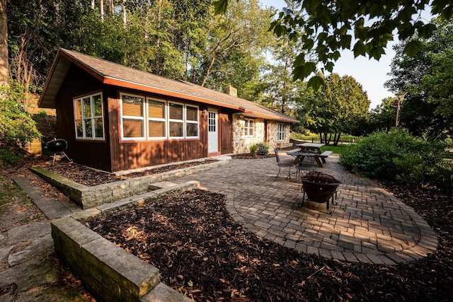 back of house featuring a patio and an outdoor fire pit