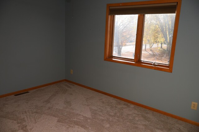 unfurnished room featuring carpet