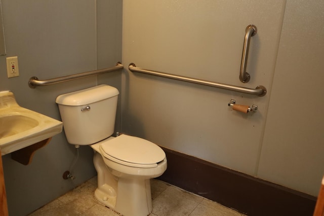 bathroom with toilet and tile patterned flooring