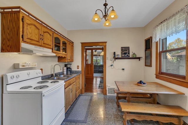 kitchen featuring sink, hanging light fixtures, white range with electric stovetop, breakfast area, and a chandelier