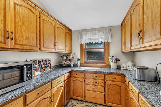 kitchen featuring dark stone counters