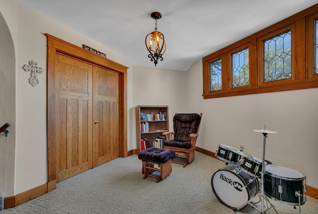 sitting room with carpet flooring and a chandelier