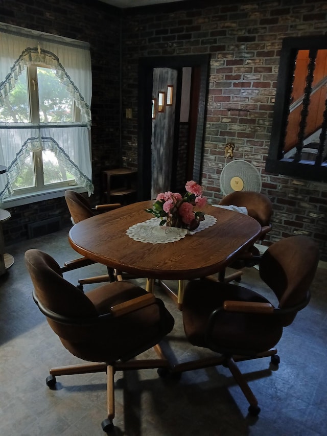 dining space with brick wall