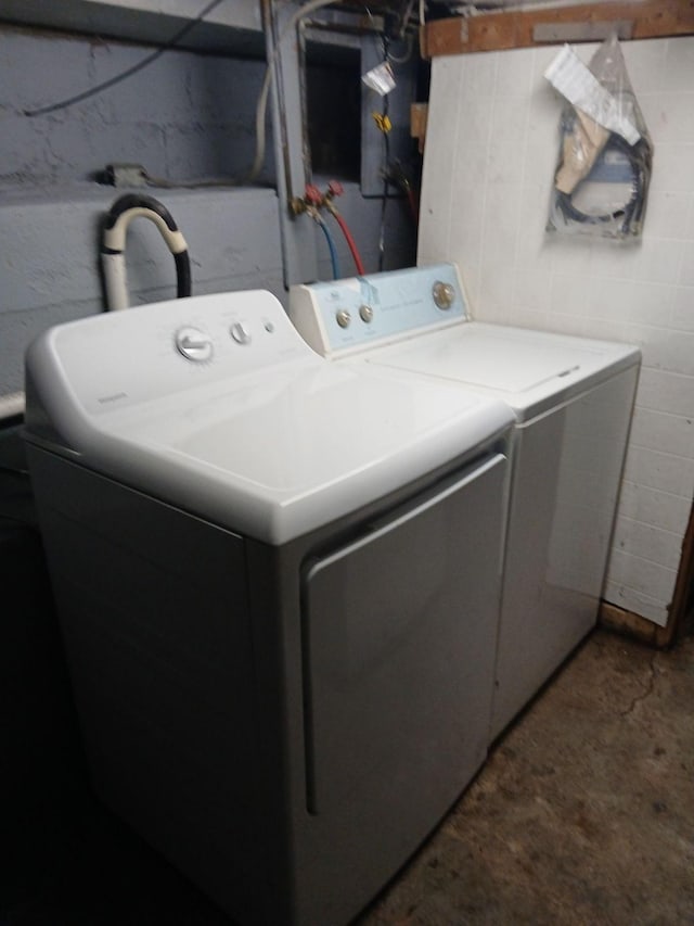 clothes washing area with independent washer and dryer