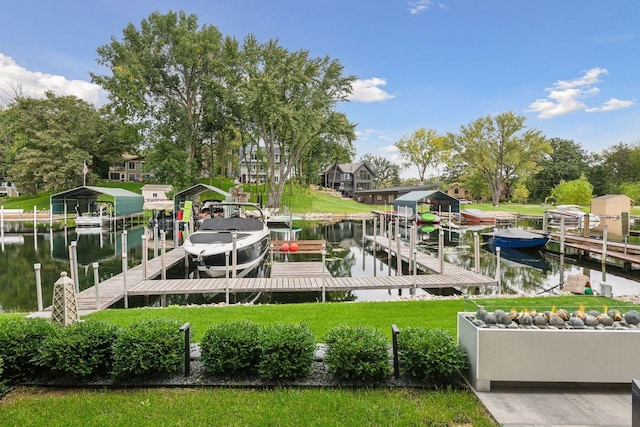 view of dock featuring a yard, boat lift, and a water view