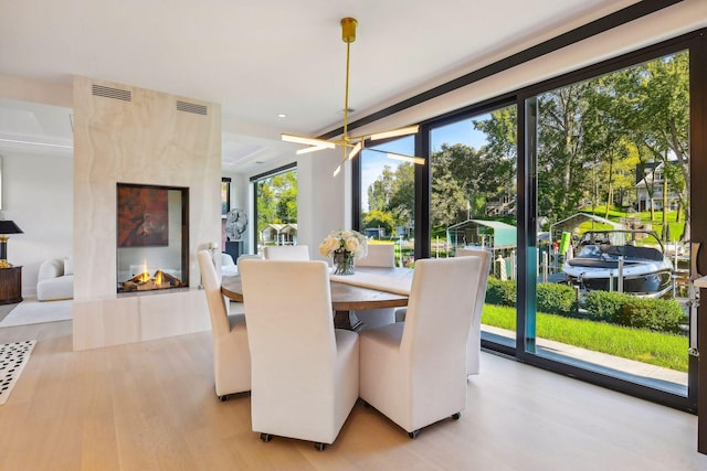 dining space featuring visible vents and wood finished floors