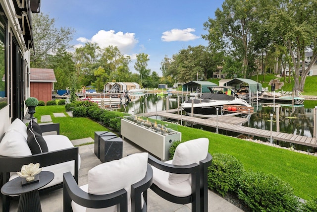 view of patio featuring a water view, a dock, an outdoor living space, and boat lift