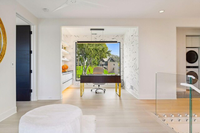 interior space featuring light hardwood / wood-style floors and stacked washer and dryer