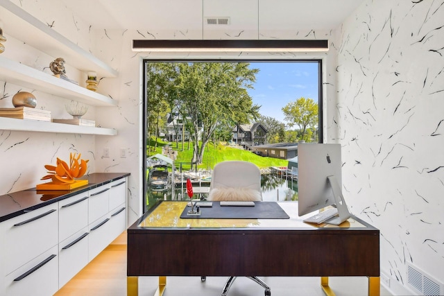 office area featuring light wood-style flooring and visible vents