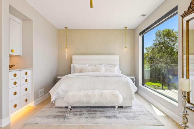 bedroom featuring visible vents, baseboards, and light wood-type flooring