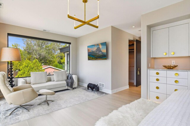 bedroom with a closet and light hardwood / wood-style floors