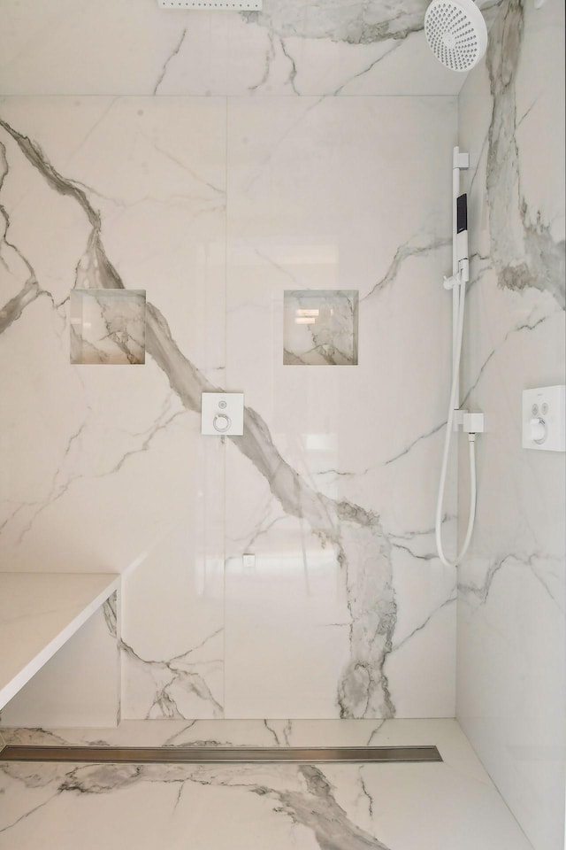 bathroom with a marble finish shower