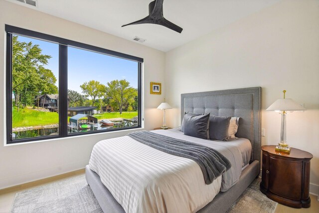 bedroom featuring wood-type flooring and ceiling fan