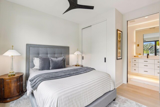 bedroom with ceiling fan, light wood-type flooring, and a closet