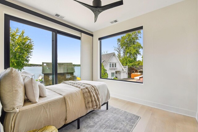 bedroom with light hardwood / wood-style floors and ceiling fan