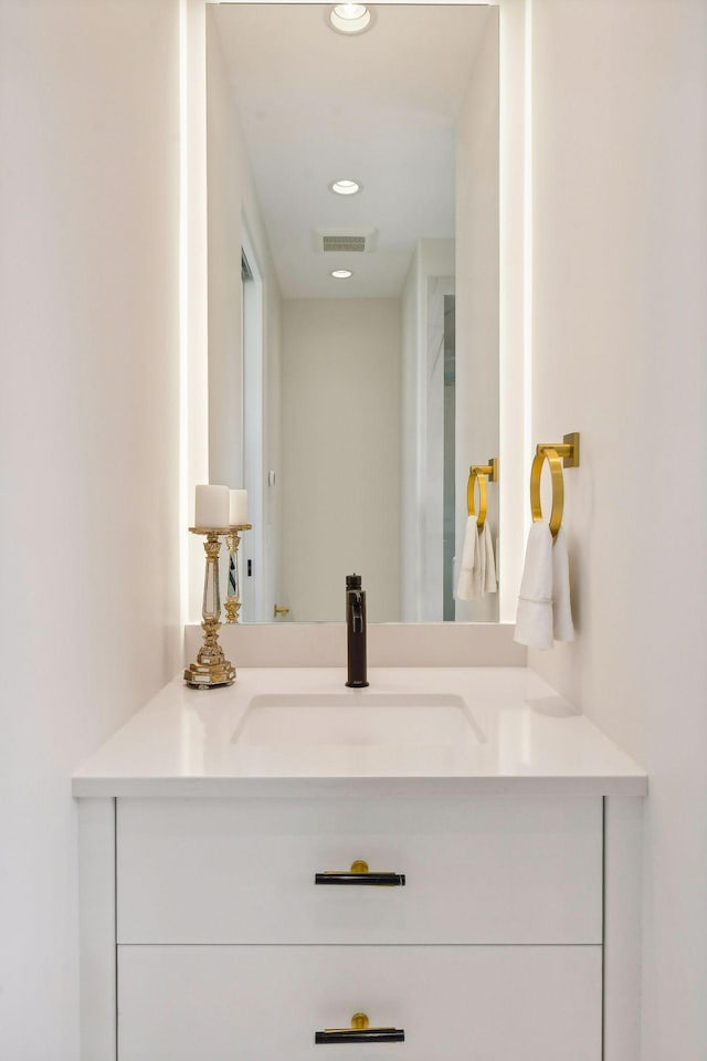 bathroom with recessed lighting, visible vents, and vanity